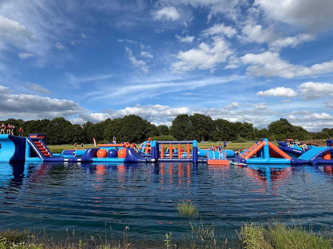 Swimmers tackling the Lakeside Adventure Aquapark obstacle course