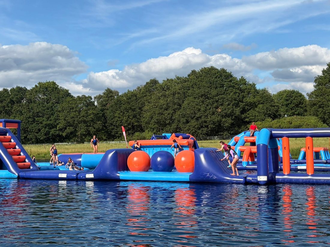 Northgate swimmers on the inflatable obstacle course